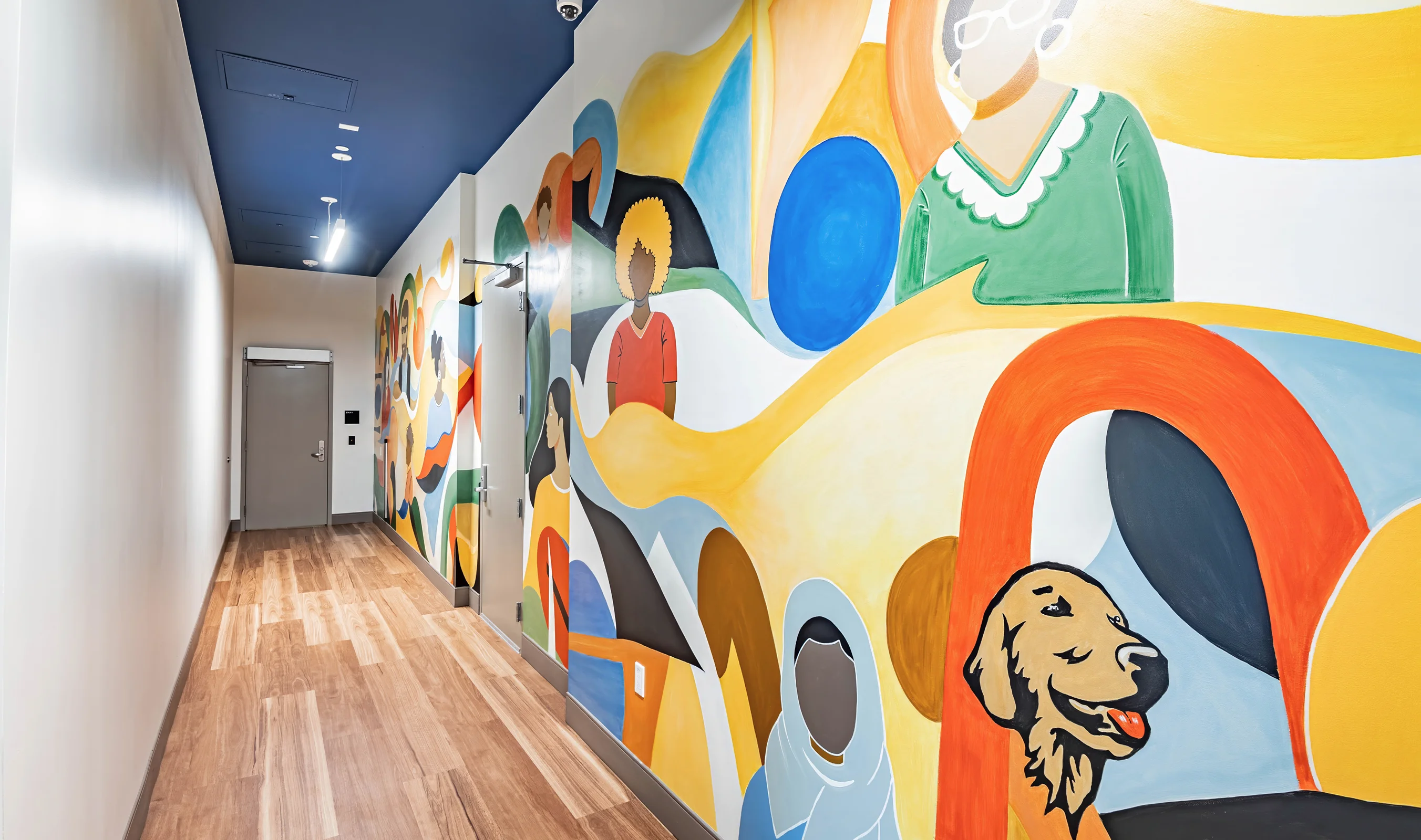 Colorful, cheerful sourced artwork mural in the hallway of the The Kelsey